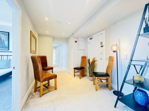 a living room with chairs and a ladder at Skyline View Apartment in Edinburgh