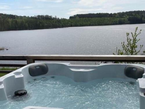 a bath tub with a view of a lake at VAR689-Amotfors-Soedra-Fjaell-Nisstorpet-1 in Berget