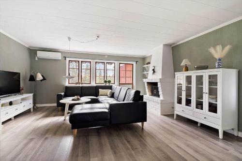 a living room with a couch and a table at KRO634-Liatorp-Garphyltan-2 in Eneryda
