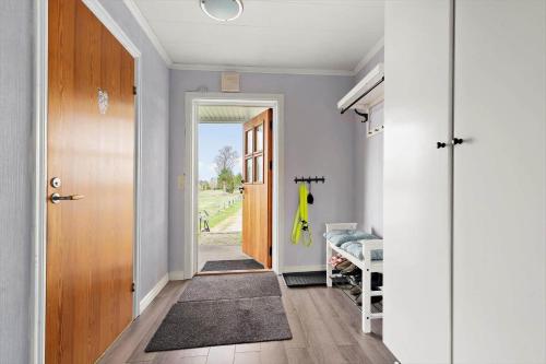a hallway with a door leading to a bedroom at KRO634-Liatorp-Garphyltan-2 in Eneryda