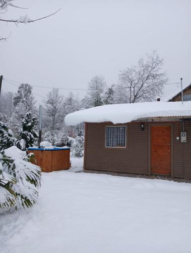 a house with snow on top of it at Cabaña Camino Termas de Chillan Hermoso Recinto in El Cerrillo