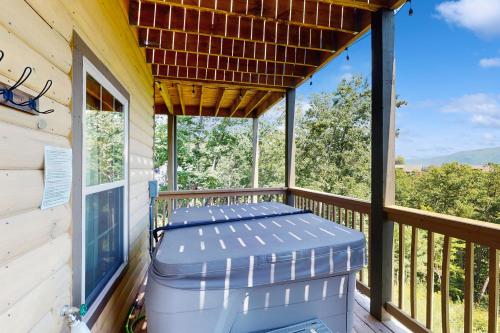 a screened in porch with a blue ottoman at 4428 Stackstone Rd, Sevierville, TN 37862 in Park Settlement