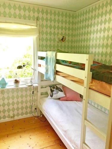 a bedroom with two bunk beds and a window at ORE739-Motala-Forsanaesvaegen-26 in Rå