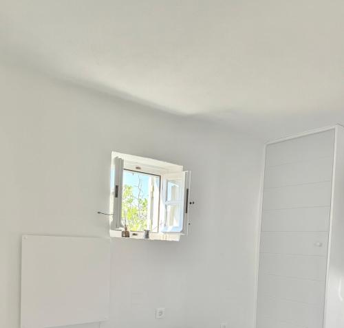 a window in a white room with a white wall at Sifnos Blue Horizon House Kastro Endless Blue in Apollonia