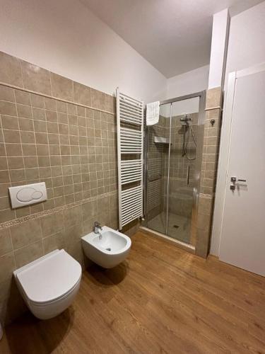 a bathroom with a toilet and a glass shower at B&B DA NONNA ANACLE in Bastia Umbra