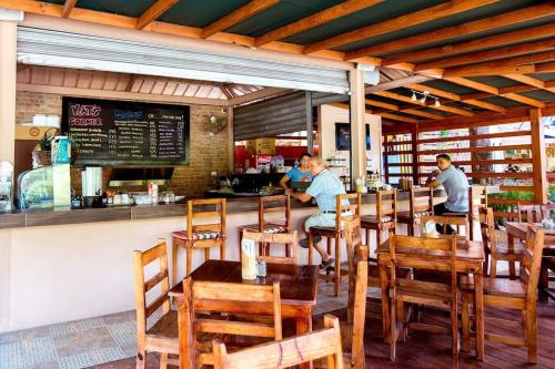 two men sitting at a bar in a restaurant at DUCASSI DELUXE playa LOS CORALES - rooftop pool and restaurants in Punta Cana