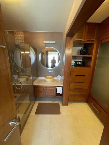 a bathroom with a sink and a mirror at Oceanview Punta Arrocito Luxury Condo, Near Arrocito Beach in Santa Maria Huatulco