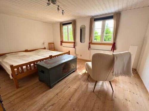 a bedroom with a bed and a table and a chair at VGO789-Svenljunga-Revesjoe-Sjoekullen-1 in Tommared