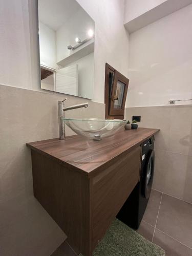 a bathroom with a glass bowl sink on a counter at Victor's House in Pacentro