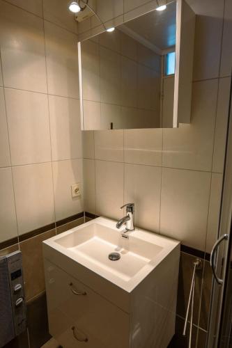 a bathroom with a sink and a mirror at L'apais'Han in Rochefort