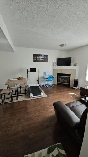 a living room with a couch and a fireplace at Basement Appartment in Edmonton