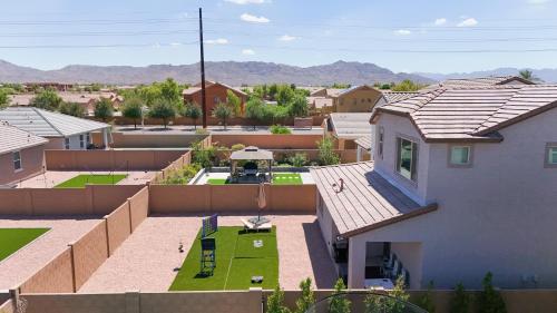 an aerial view of a house with a yard at Modern Desert Home-Great for families & groups, near golf, hiking, and city fun in Phoenix
