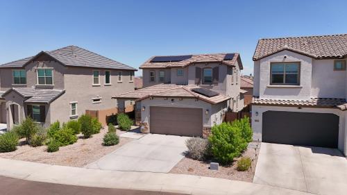 a house with a garage in a residential neighborhood at Modern Desert Home-Great for families & groups, near golf, hiking, and city fun in Phoenix