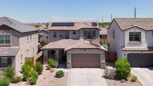 a house with a garage in a residential neighborhood at Modern Desert Home-Great for families & groups, near golf, hiking, and city fun in Phoenix