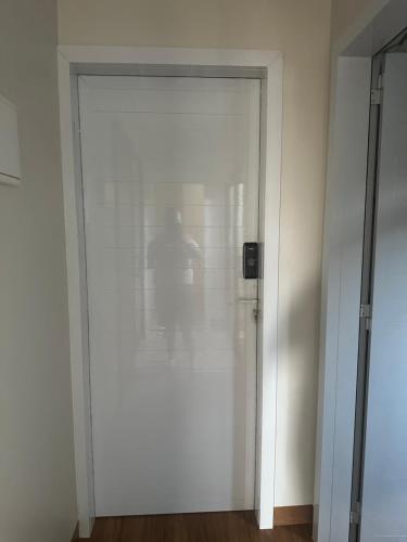 a sliding glass door with a person standing behind it at Pousada Vila Rica in Sorriso