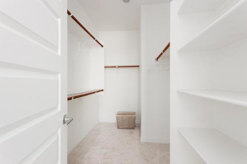 a hallway with white walls and a white closet at Modern Desert Home-Great for families & groups, near golf, hiking, and city fun in Phoenix