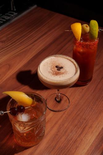 a wooden table with two cocktails and a drink at The Delaney Hotel in Orlando