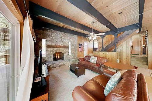 a living room with a couch and a fireplace at Conifer Donner in Truckee