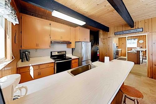 a kitchen with wooden cabinets and a white counter top at Conifer Donner in Truckee