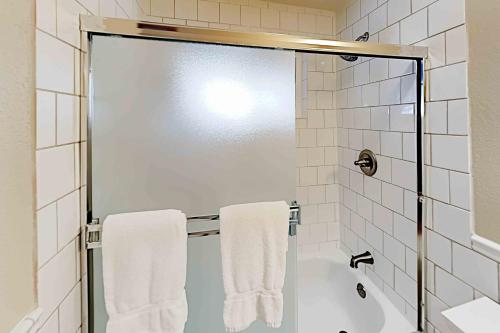 a bathroom with a shower with white towels at Conifer Donner in Truckee