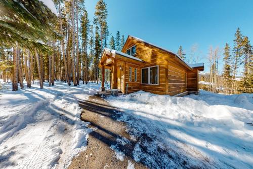 a log cabin in the woods in the snow at American Way Chalet in Breckenridge