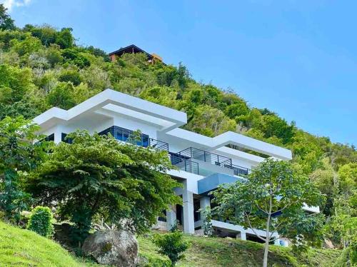 a large white house on a hill at Villa Modere' in Tortola Island