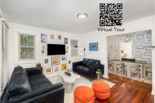 a living room with black leather furniture and a table at Walkable City Trendy Hideout for Foodies - 3BR-2BA in Charlotte