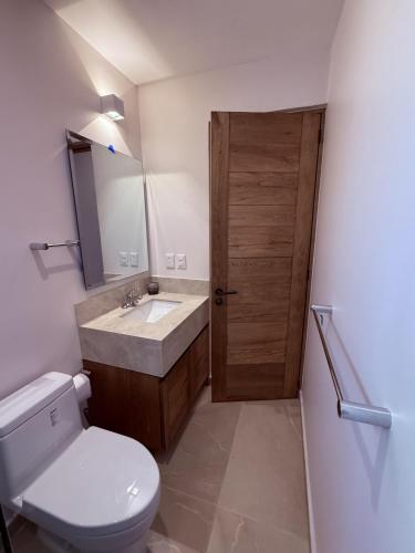 a bathroom with a toilet and a sink at Costta Loft L1 - Santa Cruz in Santa Cruz Huatulco