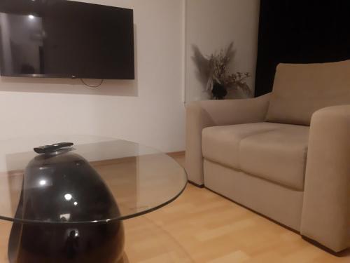 a living room with a glass table and a couch at CenterZeroZoneOne in Banja Luka