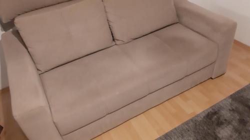 a white leather couch in a living room at CenterZeroZoneOne in Banja Luka
