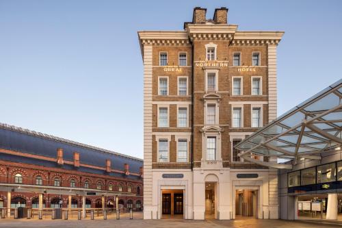 a large brick building next to two other buildings at Kaya Great Northern Hotel, London in London