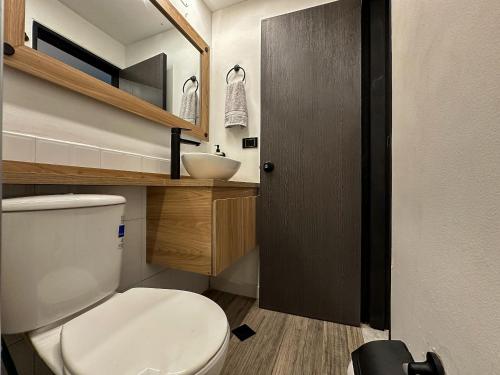 a small bathroom with a toilet and a sink at Apartaestudio Moderno San Fernando Sector Estadio in Cali