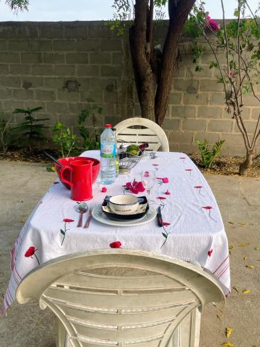 a table with a white table cloth with flowers on it at Harena Villa in Morondava