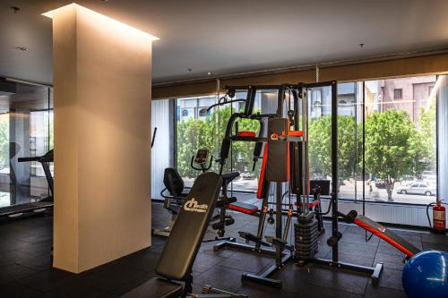 a fitness room with a gym with tread machines at Tuvana Hotel in Jeddah