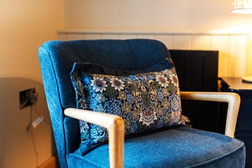 a blue chair with a pillow on it at Central Whitchurch - Lowcross House Guest Bedroom 6 in Whitchurch