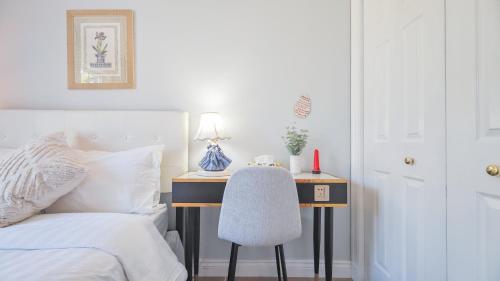 a bedroom with a bed and a desk with a chair at Diana House in Charlottetown