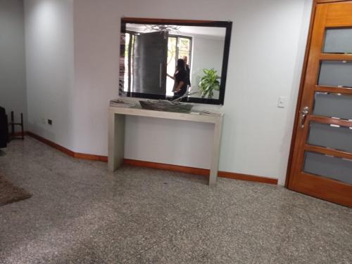 a mirror on a table in a room with a person in it at Departamento de Lujo sector Bosmediano in Quito