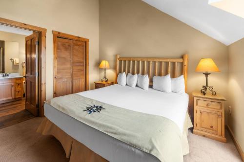 a bedroom with a large bed and a bathroom at River Run Village by Keystone Resort in Keystone