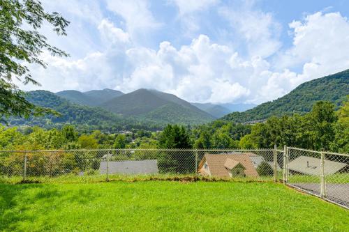 a fence in a field with mountains in the background at Ski, Hike and Fish Mtn-View Maggie Valley Retreat in Maggie Valley