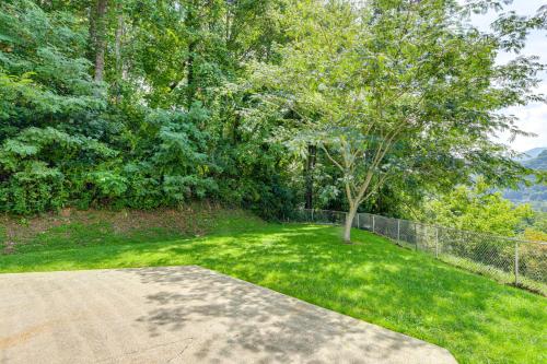 a yard with a tree and a fence at Ski, Hike and Fish Mtn-View Maggie Valley Retreat in Maggie Valley