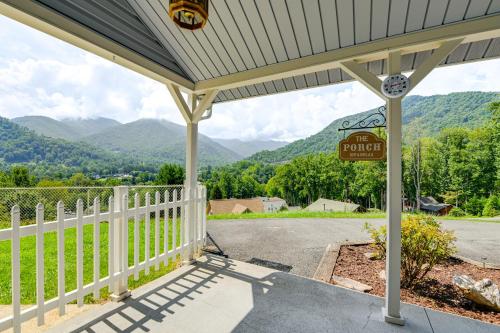 a porch with a fence and mountains in the background at Ski, Hike and Fish Mtn-View Maggie Valley Retreat in Maggie Valley