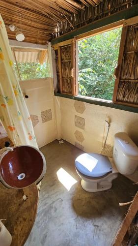 a small bathroom with a toilet and a sink at Casa da Ilha Cotijuba in Belém