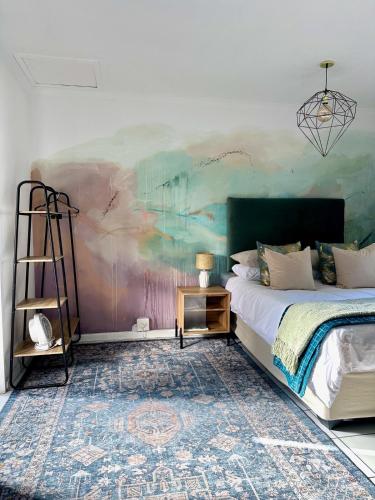 a bedroom with a bed and a painting on the wall at Little Studio in Tokai in Tokai