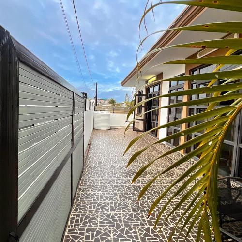 a patio with a fence and a plant next to a building at Casa Soleil in Grand Baie