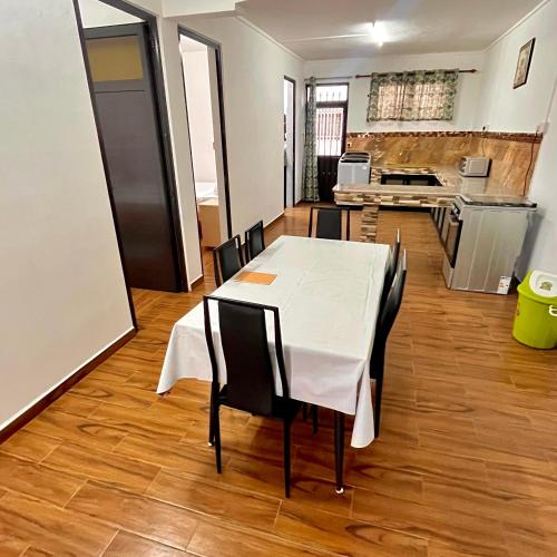a dining room with a table and chairs and a kitchen at Casa Soleil in Grand Baie