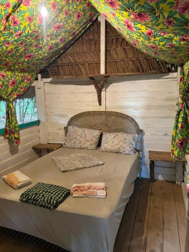 a bed in a room with a tent at Casa da Ilha Cotijuba in Belém