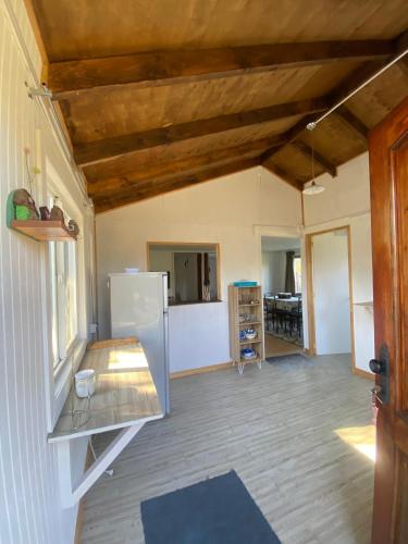 a kitchen and living room with a refrigerator at Cabaña Ruta Petrohue in Ensenada