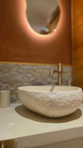 a bathroom sink with a marble bowl on a counter at Escape Zen - Suite and Spa in Chambly