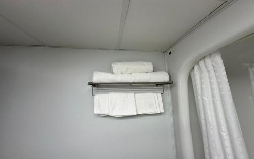 a group of towels on a towel rack in a bathroom at Lac House Inn in Lac du Bonnet