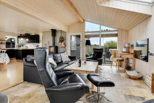 a living room with a couch and a table at HS010-Henne-Hjelmevej-7 in Henne Strand